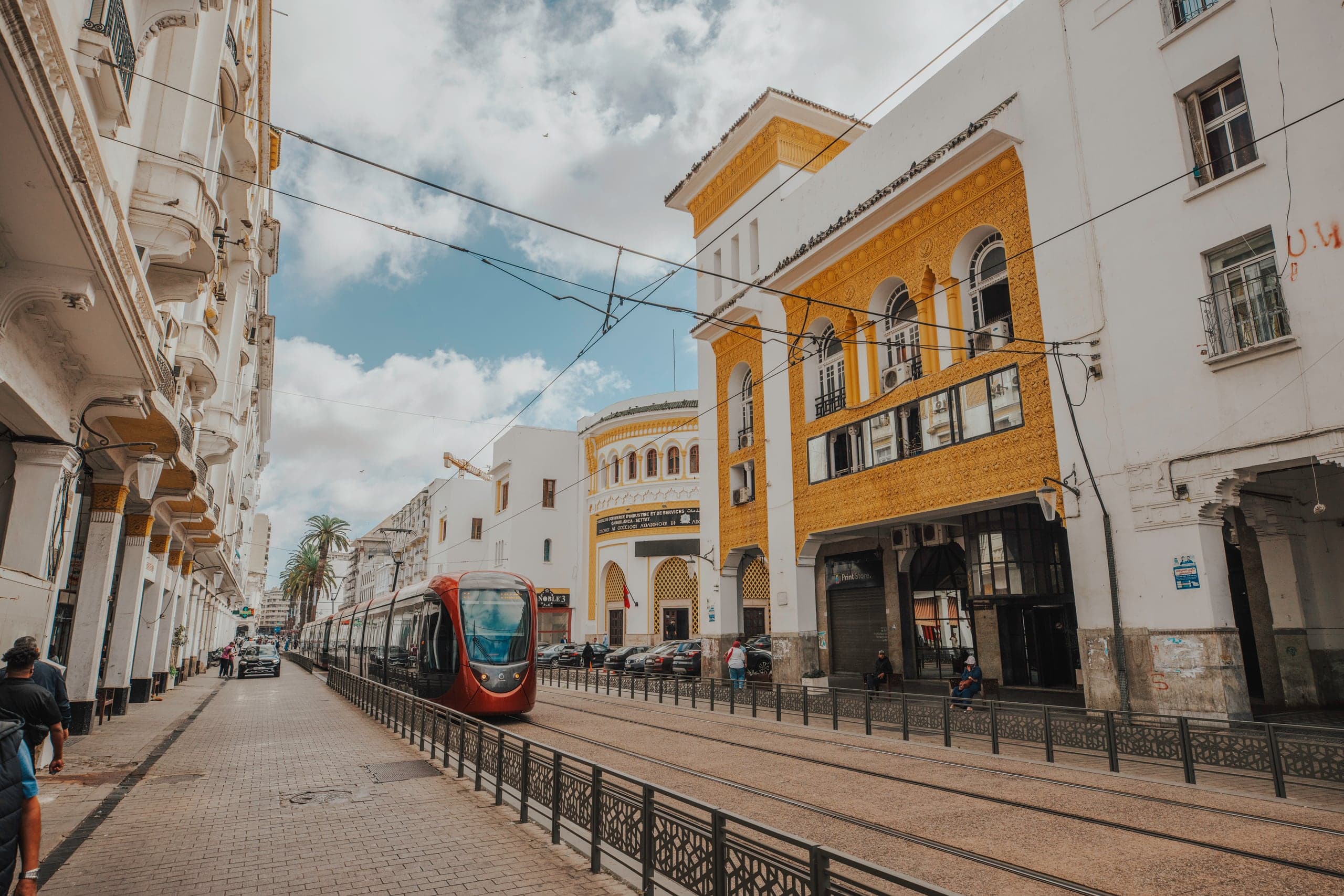 A tram passing white art deco buildings in central Casablanca