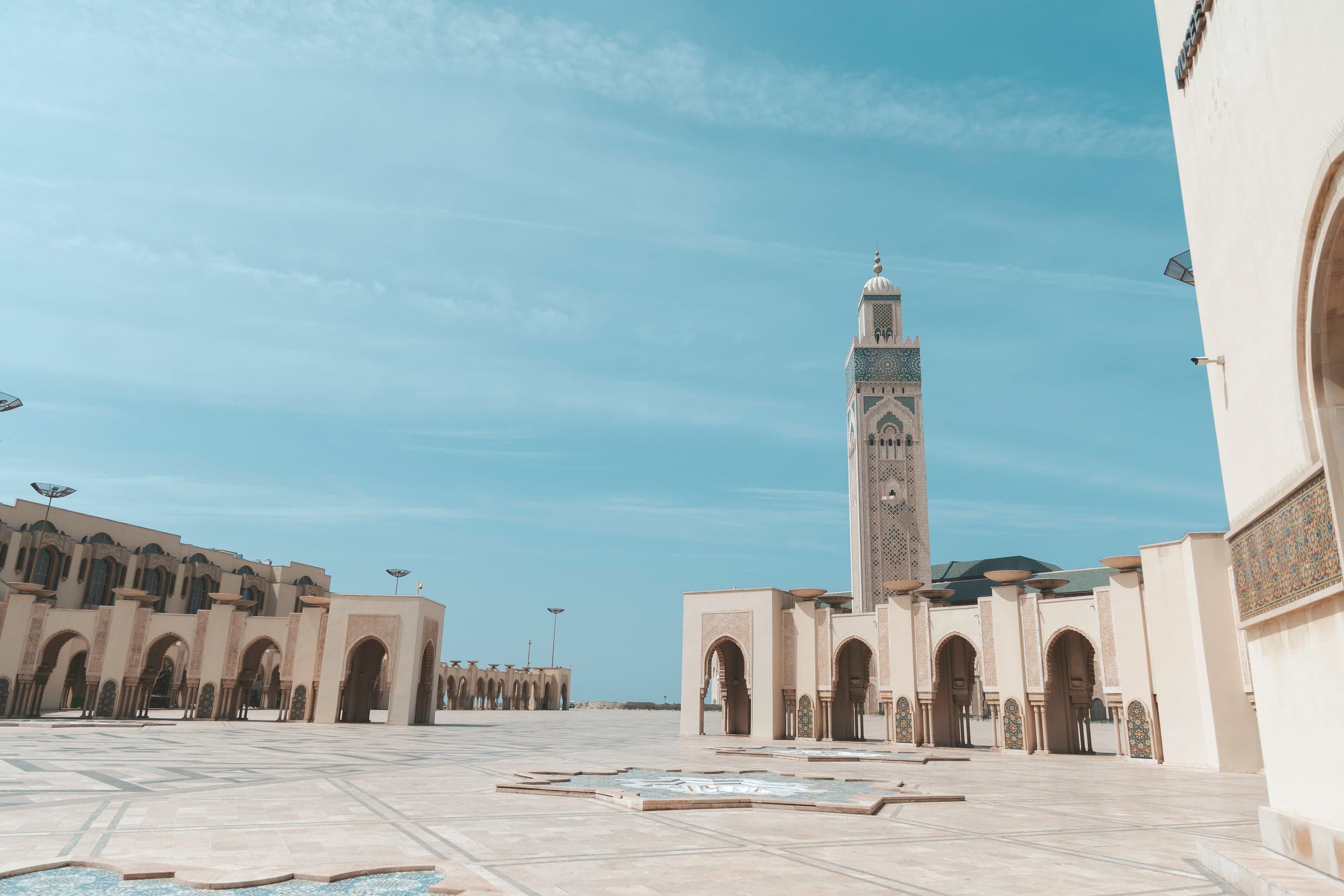 The Hassan II Mosque and its minaret across a vast marble esplanade