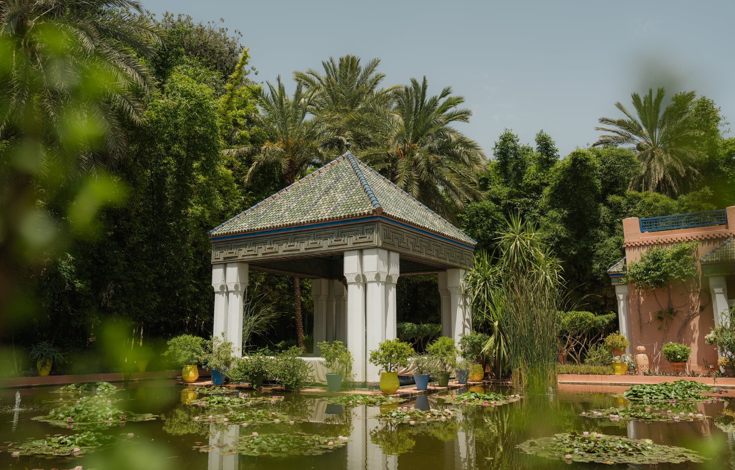 A green-tiled pavilion above a lily pond in the Majorelle Garden